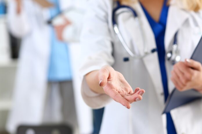 Female doctor offer helping arm closeup